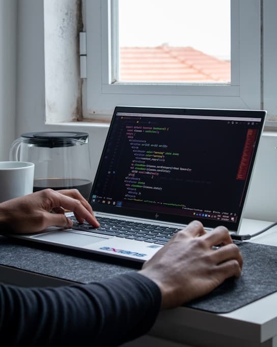Front-end developer writing code at Cambridge Motion